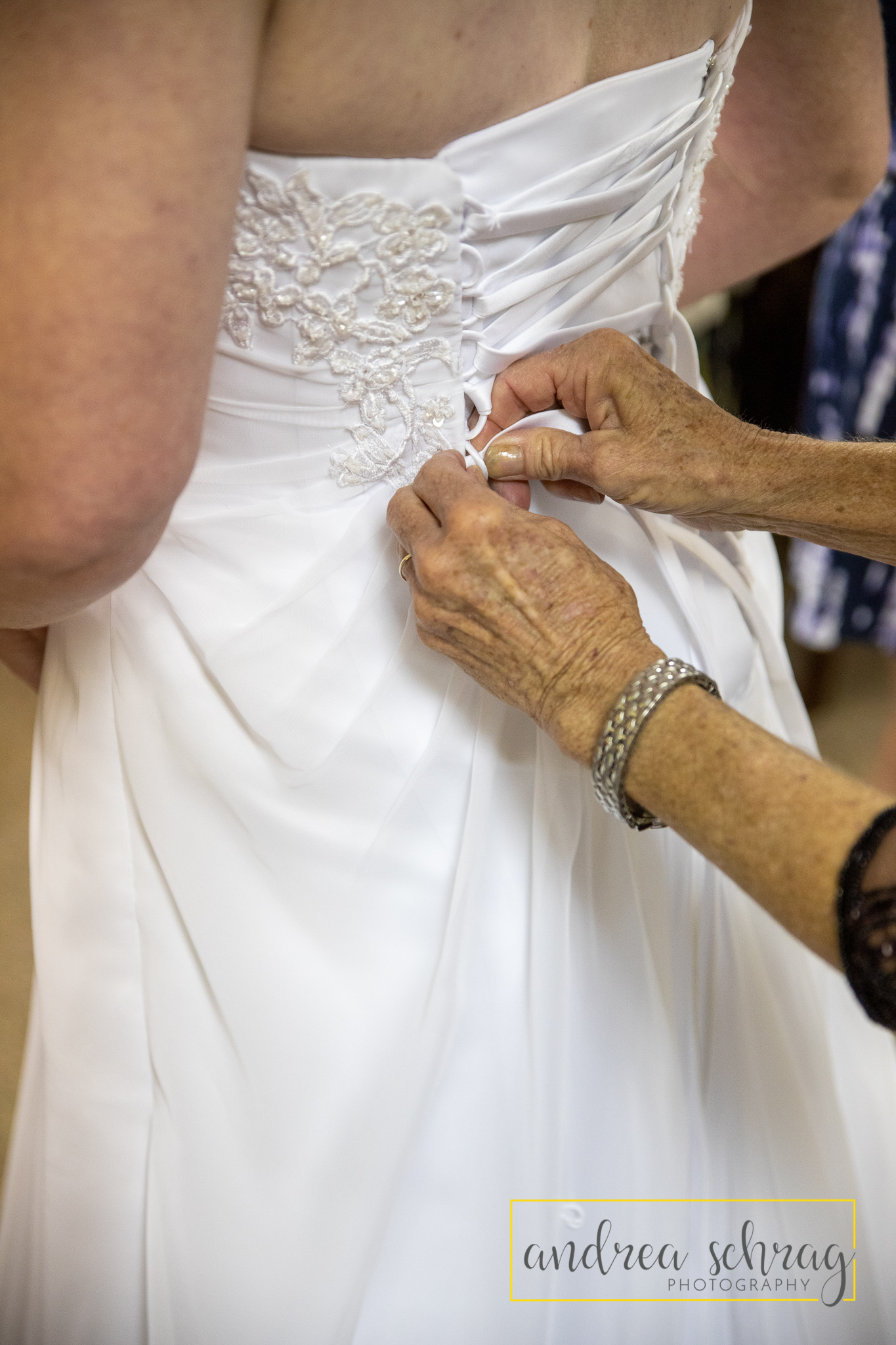 bride in dress with mother