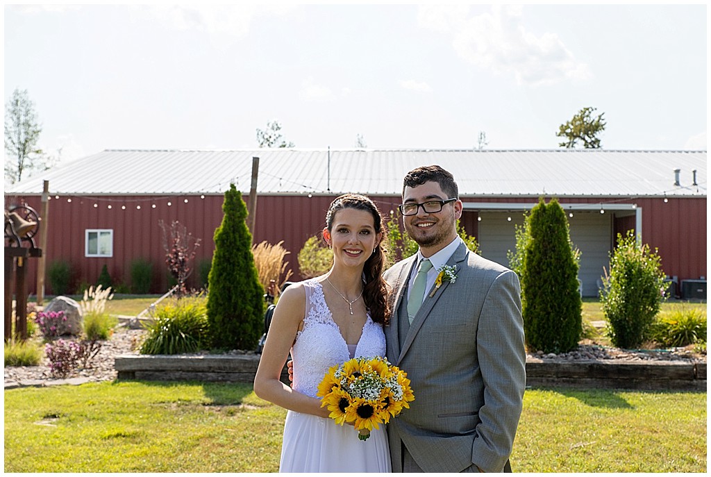 Bride and groom summer wedding with sunflowers at Lakeside Wedding Venue and Event Center
