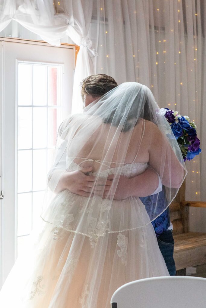 bride and groom hugging