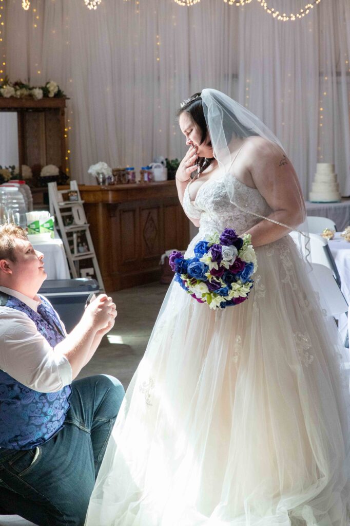 groom presenting bride with engagement ring
