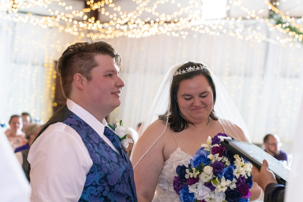 bride and groom at altar at lakeside wedding venue