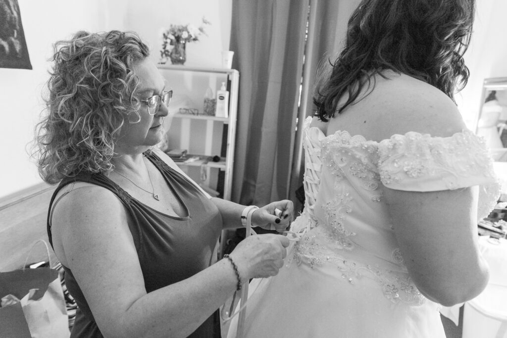 black and white photo of bride getting ready with mom