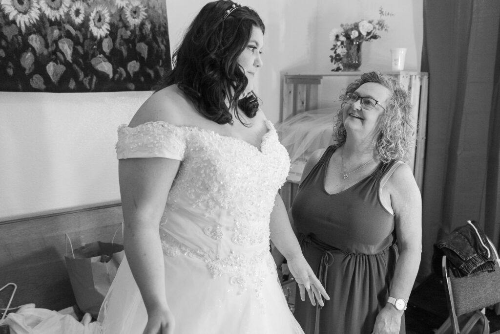 black and white photo of bride getting ready with mom