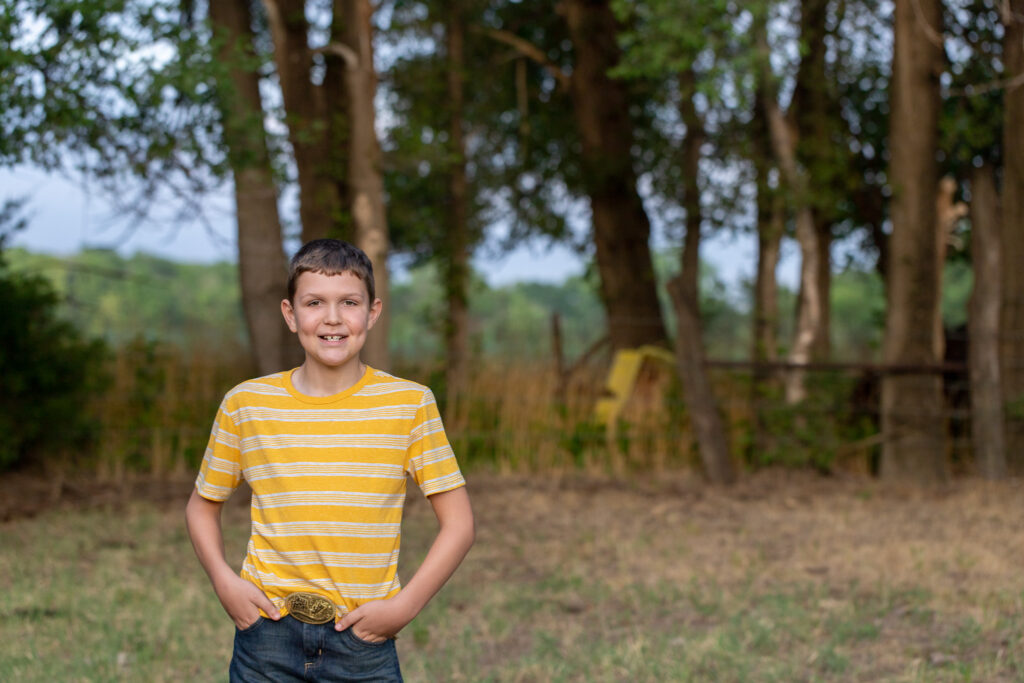 smiling boy in yellow shirt