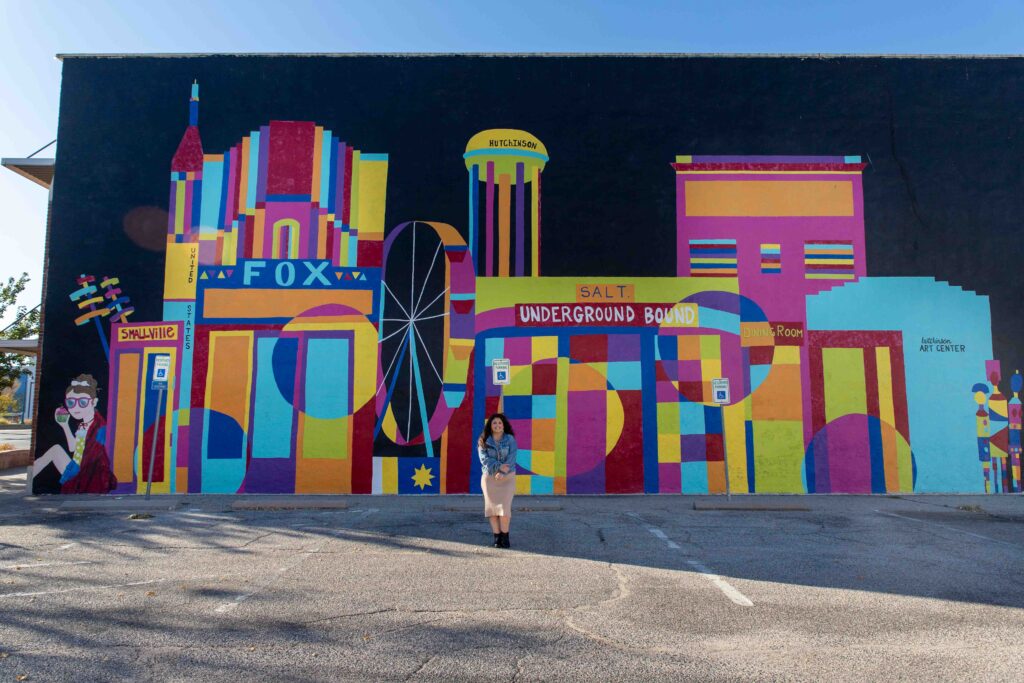 high school senior girl in front of mural in downtown hutchinson ks